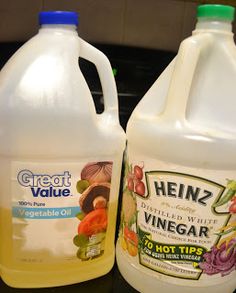 two gallon jugs of vinegar sitting next to each other