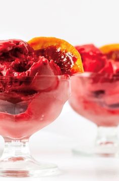 two glasses filled with ice cream and fruit