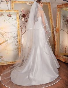 a woman in a white wedding dress and veil