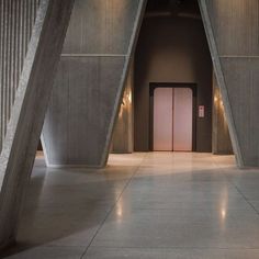 the entrance to an empty building with columns