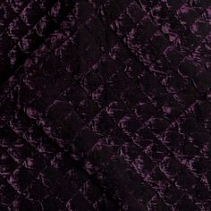 the fabric is dark purple and has an intricate pattern