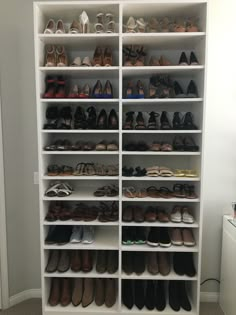 a white shoe rack filled with lots of shoes