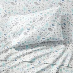 an image of a bed with blue and white sheets