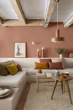 a living room filled with lots of furniture next to a white couch and coffee table