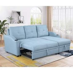 a blue couch with a pull out bed underneath it