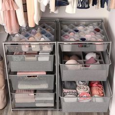 an organized closet with two bins filled with clothes and other items on hangers