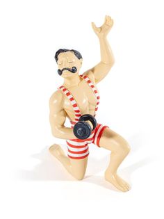 a ceramic figurine of a man with a gas mask and red striped shorts