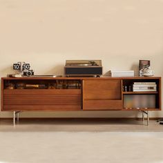 an old record player sitting on top of a wooden entertainment center in a living room