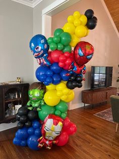 a bunch of balloons that are in the shape of avengerss and spiderman characters