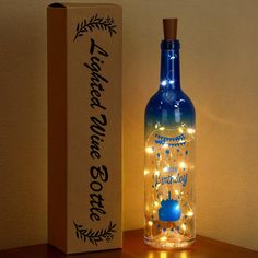 a bottle that is sitting on a table next to a box with lights in it