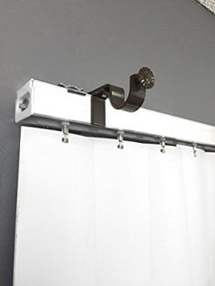 the curtain is pulled back and secured to the wall by two metal brackets, which are attached to the outside of the window