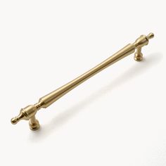 an antique brass cabinet handle on a white background