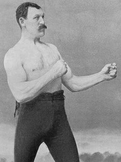 an old black and white photo of a man holding a frisbee in his right hand