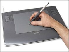 a hand holding a pen and writing on an electronic device