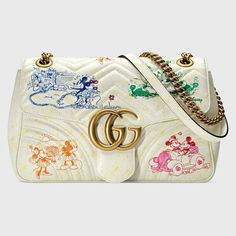 The playful image of Mickey and Minnie Mouse defines this GG Marmont small shoulder bag in ivory matelassé leather. In celebration of the Lunar New Year, Disney’s legendary characters appear throughout Gucci’s ready-to-wear and accessories for the Cruise 2020 collection, displayed as colorful prints, embroidered patches or jacquard motifs. Disney x Gucci ©Disney Multicolor Mickey and Minnie Mouse print ivory matelassé chevron leather Online Exclusive Antique gold-toned hardware Internal leather tag with © Disney Microfiber lining with a suede-like finish To celebrate the Lunar New Year, Disney and Gucci come together for an exclusive collection. With a vintage inspired attitude, the emblematic cartoon character Mickey Mouse stands out against a green background, decorating the dedicated pa Gg Marmont Small Shoulder Bag, Gucci Belt Sizes, Tas Bahu, Mickey Y Minnie, Mouse Print, Chain Strap Bag, Card Case Wallet, Gucci Gg Marmont, Round Bag