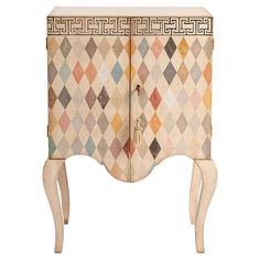 an antique cabinet with geometric designs on the doors and drawers, painted in multicolors