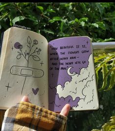 someone is holding up an open book with drawings on it and the pages are purple