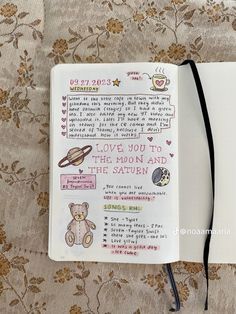 an open notebook with writing on it and a teddy bear drawn in the page next to it