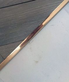 a close up of a metal object on a wooden floor