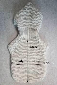 a white knitted hot water bottle cover with measurements