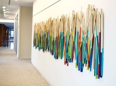 the wall is decorated with many different colored sticks