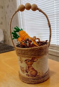 an easter basket with eggs, carrots and other things in it sitting on a table