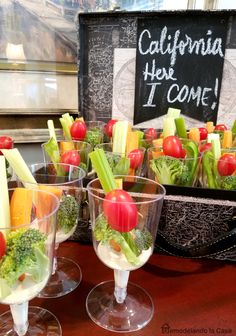 several glasses filled with different types of vegetables