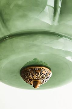 a close up of a green glass light fixture