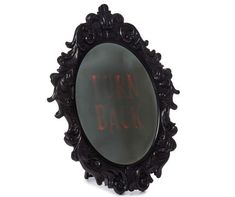 a mirror with the words turn back written in red on it's side and an ornate frame