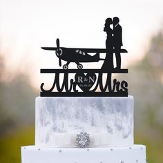 a wedding cake topper with an airplane on it