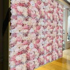 the wall is covered with pink and white flowers