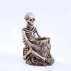 a skeleton sitting on top of a tree stump