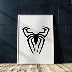 a black and white spider logo on a wall