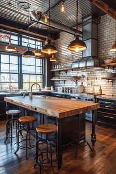 an industrial style kitchen with wood floors and black cabinets, wooden counter tops and stools