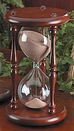 an hourglass sitting on top of a wooden table