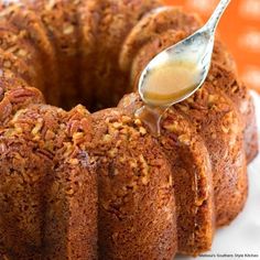 a close up of a bundt cake on a plate with a spoon in it