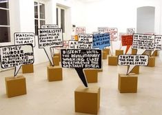 a room filled with lots of different types of signs on wooden blocks and cardboard boxes