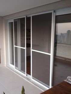 an empty room with sliding glass doors on the outside