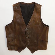 Vintage William Teague Leather Vest Jacket Size 42 Brown Condition/Description Good condition.  Photos will highlight any imperfections on the item. Please refer to the photos to see the specific condition of the item.  Measurements: Pit to pit - 20.5" Length - 20" Due to the nature of vintage clothing, size in title may not accurately represent the measurement of the item. Please refer to the measurements above to ensure the right fit. CONDITION LEGEND Excellent - Free of marks, stains, holes, or loose stitching. Great - Minor cracking or pilling; items may have minor marks or stains (free of fraying, loose stitching, and holes/rips). Good - May have minor marks/stains, minor yellowing, small holes, loose stitching, or fraying. Satisfactory - May have marks & stains, rips, tears, and/or y Leather Vest Jacket, Leather Vest, Vest Jacket, Vintage Clothing, Favorite Outfit, Mens Jackets, Vintage Outfits, Jackets & Coats, Im Not Perfect