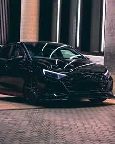 a black car parked in front of a building