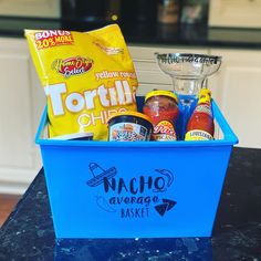 a blue container filled with condiments and other items on top of a counter