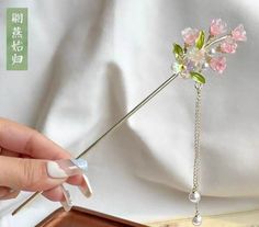 Elegant titanium steel Hair Stick Pin, featuring a delicate beautiful flower adorned with a shimmering traditional tassel. Crafted with precision, this beautiful accessory is made from high-quality sandalwood, known for its lightness and smooth texture. The 7-inch length offers a perfect balance of elegance and functionality, making it easy to style and secure in various hair types.        Care Instructions: To maintain the beauty and integrity of this hair stick pin, avoid exposing it to harsh Pink Ethereal, Ethereal Hair, Blank Hats, Hair Stick, Elegant Flowers, Stick Pins, Hair Sticks, Flower Hair, Smooth Texture