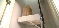 a brown paper bag sitting on top of a white shelf