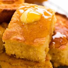 several pieces of cake sitting on top of each other with lemons in the background