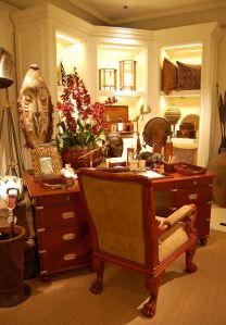 a room filled with lots of furniture and decor on top of carpeted flooring