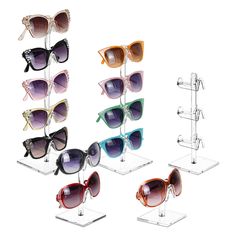 several pairs of sunglasses are on display in the shape of glasses with different colors and shapes