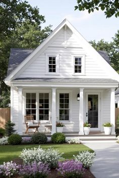 a white house with black shutters and windows