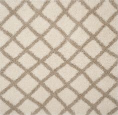 a white rug with brown squares on the top and bottom, in an area that is very