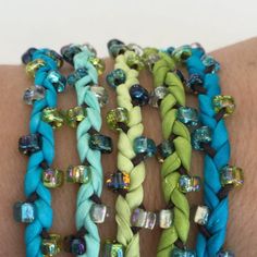 several different colored bracelets on someone's arm