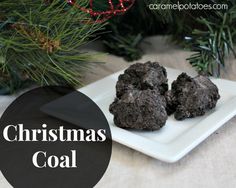 christmas coal cookies on a white plate with pine branches in the background and text overlay